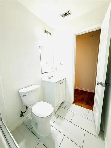 a bathroom with a toilet a sink and shower
