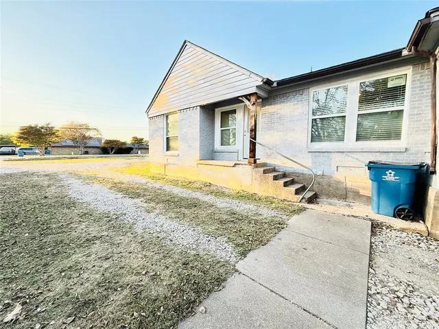 a view of a yard with trees in front of it