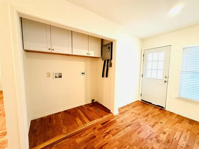 a view of a room with wooden floor and cabinet