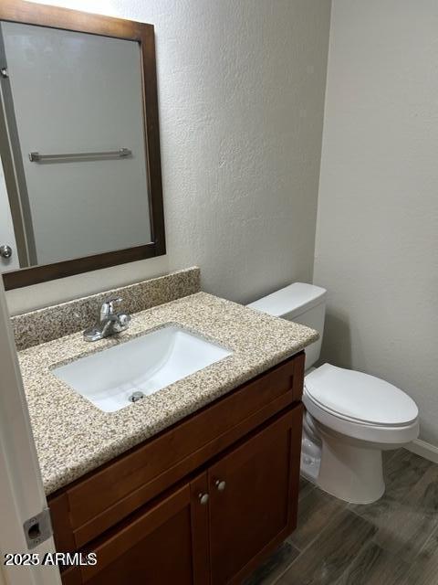 9832 East La Palma Avenue, Unit 2 Gold Canyon, AZ 85118 - Photo 19 of 24 a bathroom with a granite countertop toilet sink and mirror