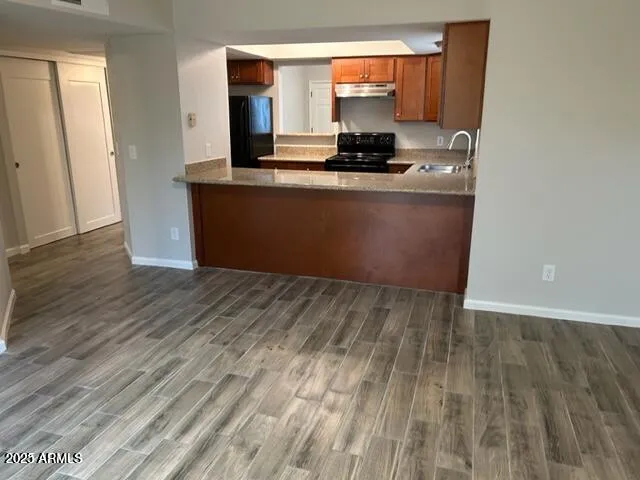 a kitchen with stainless steel appliances a sink stove and cabinets