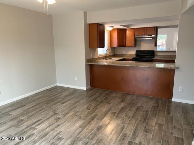 9832 East La Palma Avenue, Unit 2 Gold Canyon, AZ 85118 - Photo 5 of 24 a living room with granite countertop a sink and a stove top oven