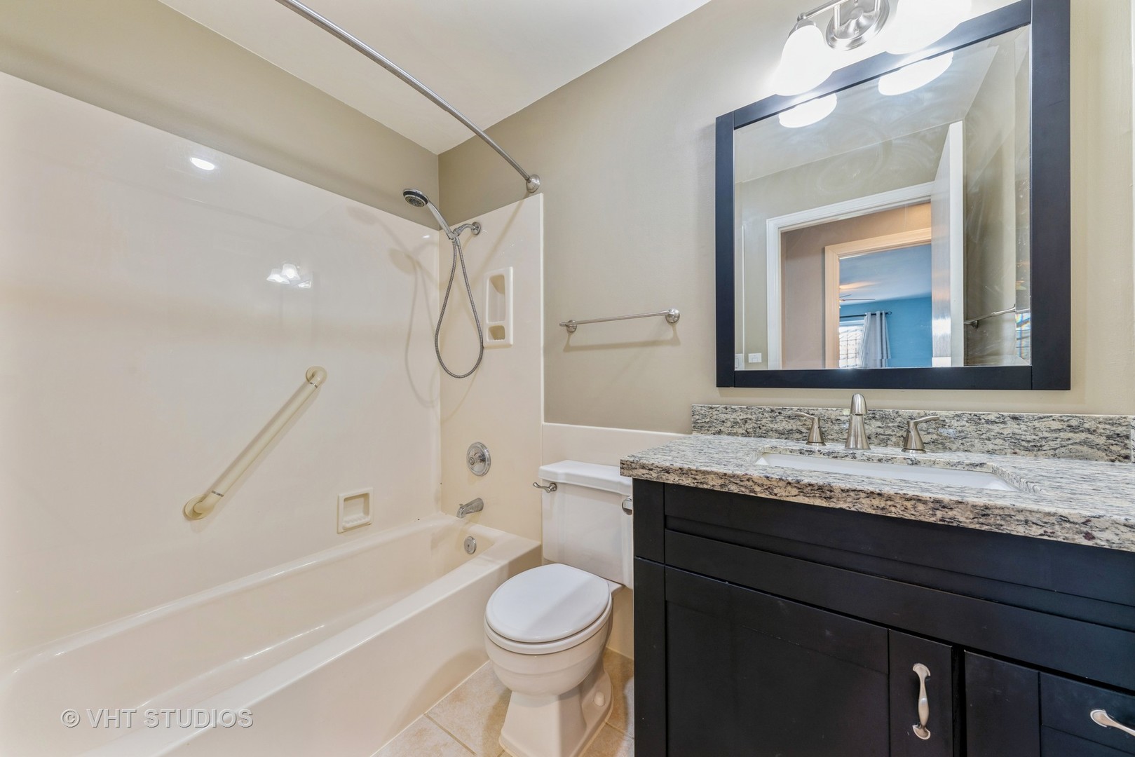 5100 Carriageway Drive, Unit 109 Rolling Meadows, IL 60008 - Photo 11 of 12 a bathroom with a granite countertop toilet sink and mirror