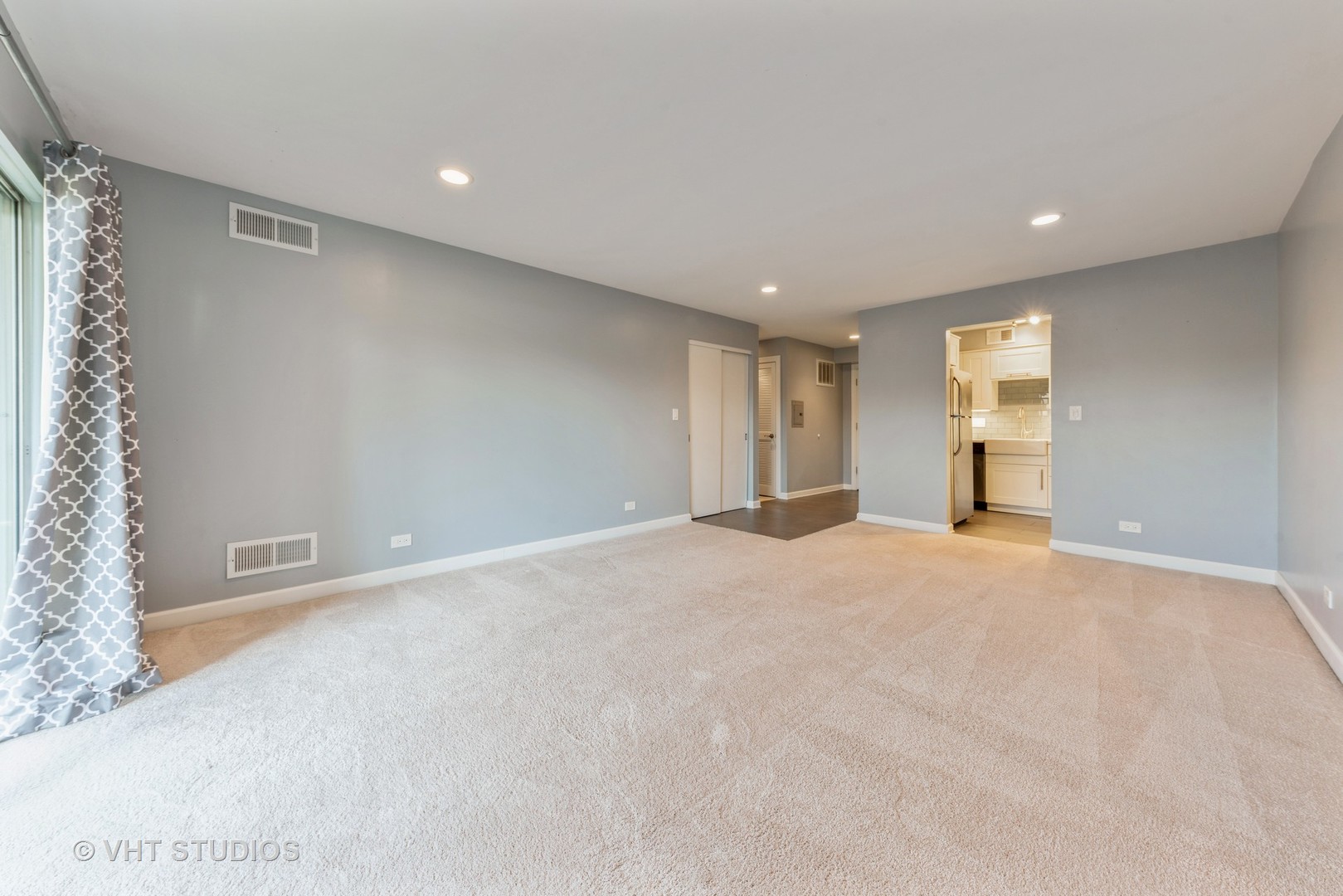 5100 Carriageway Drive, Unit 109 Rolling Meadows, IL 60008 - Photo 4 of 12 a view of an empty room with a window