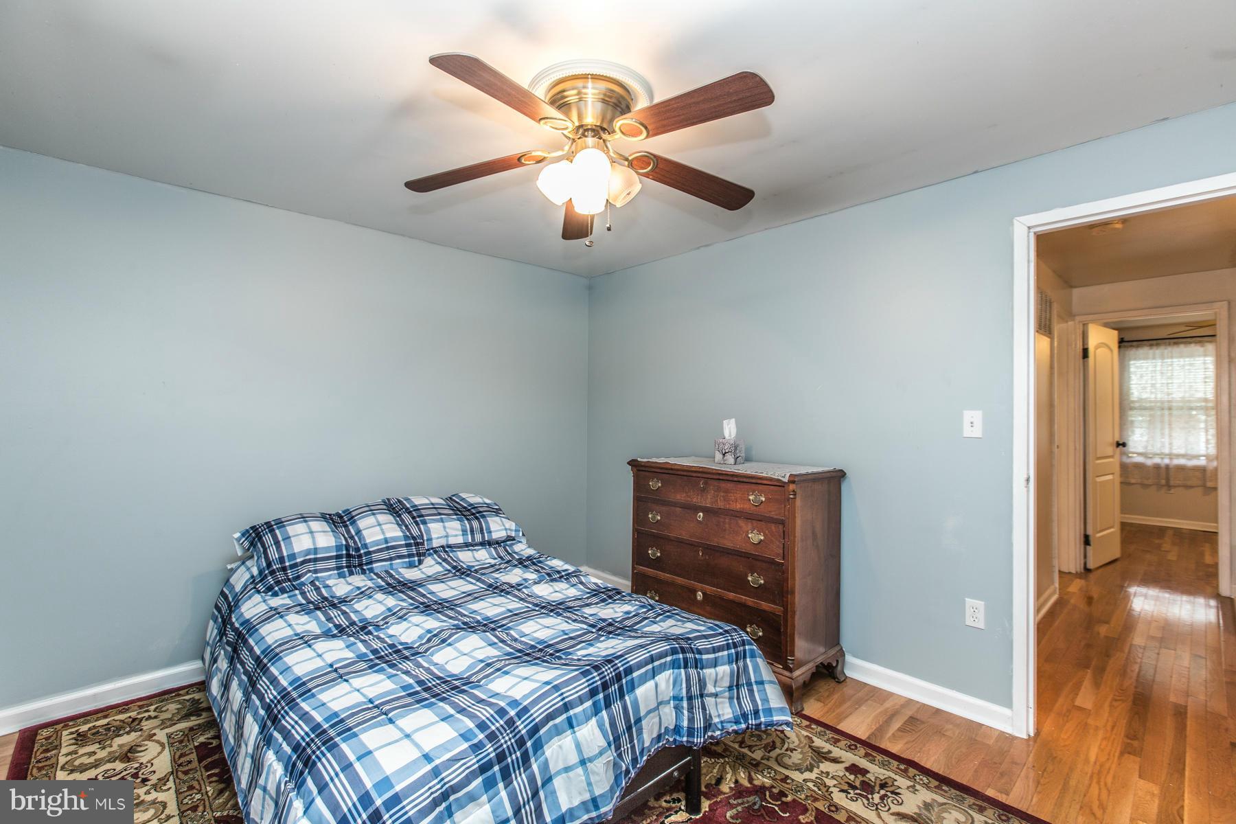 8009 Wynbrook Road Baltimore, MD 21224 - Photo 13 of 27 a bedroom with a bed and a chandelier