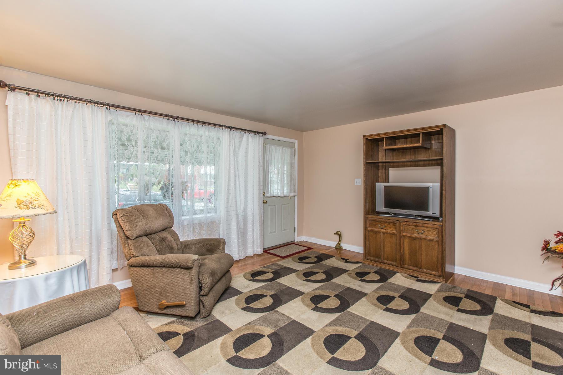 8009 Wynbrook Road Baltimore, MD 21224 - Photo 5 of 27 a bedroom with a bed and wooden floor