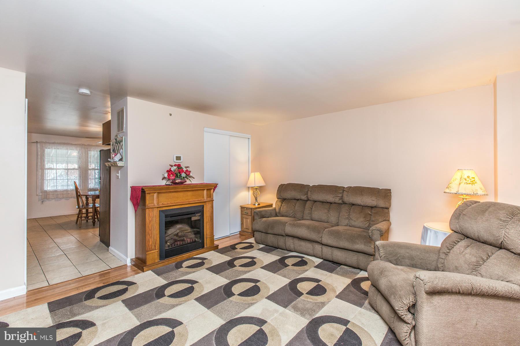 8009 Wynbrook Road Baltimore, MD 21224 - Photo 6 of 27 a living room with furniture and a fireplace
