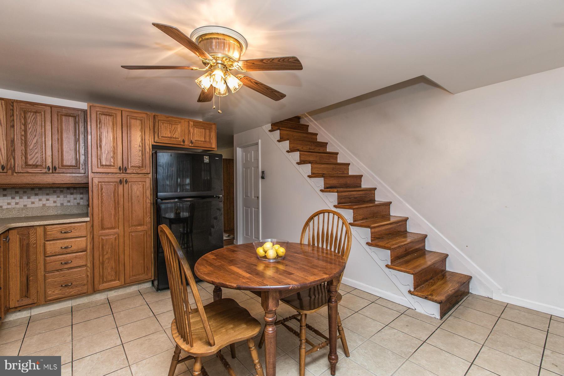 8009 Wynbrook Road Baltimore, MD 21224 - Photo 10 of 27 a view of a dining room with furniture and wooden floor