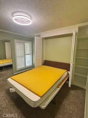 a blue bed sitting in a room next to a window
