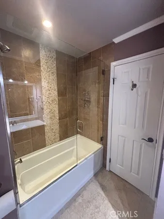 a bathroom with a bathtub and a shower