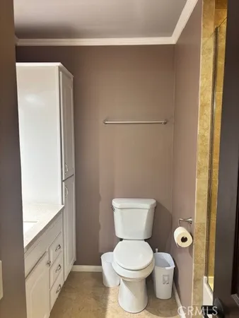 a bathroom with a toilet a sink and a mirror