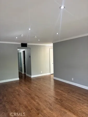 an empty room with wooden floor and closet