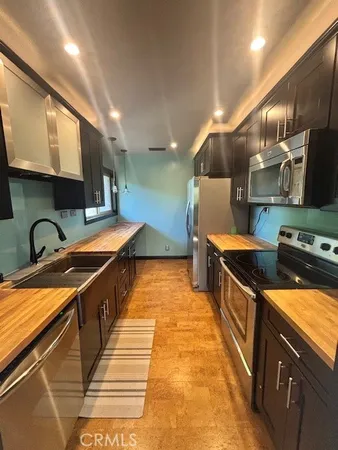 a kitchen with stainless steel appliances granite countertop a stove and a sink