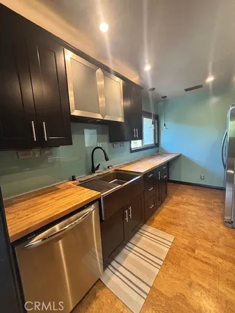 a kitchen with stainless steel appliances granite countertop a sink stove and cabinets