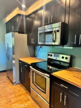 a kitchen with stainless steel appliances a stove a microwave and a refrigerator