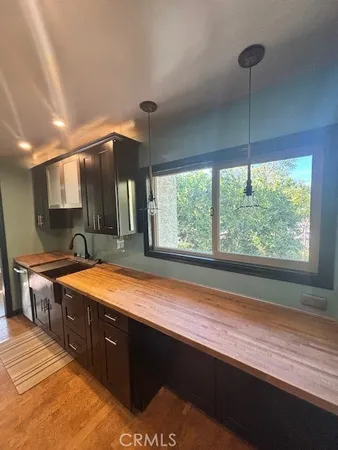 a spacious bathroom with a granite countertop sink and a large mirror
