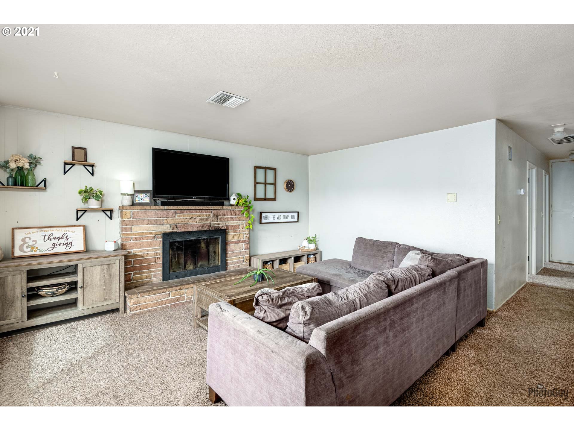 1872 I Street Springfield, OR 97477 - Photo 5 of 24 a living room with furniture a flat screen tv and a fireplace