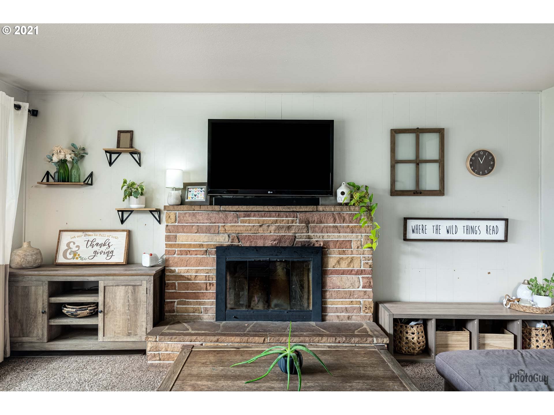 1872 I Street Springfield, OR 97477 - Photo 6 of 24 a living room with furniture a flat screen tv and a fireplace