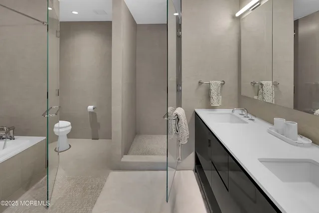 a large bed sitting in a bedroom next to a large window