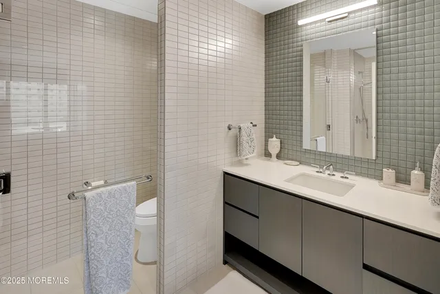 a bathroom with a sink toilet and shower