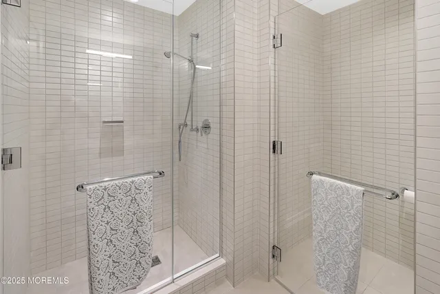 a large bed sitting in a bedroom next to a window