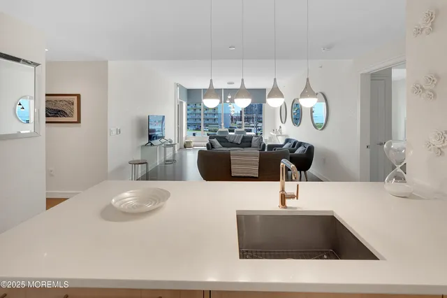 a kitchen with kitchen island granite countertop a sink a counter top space and cabinets