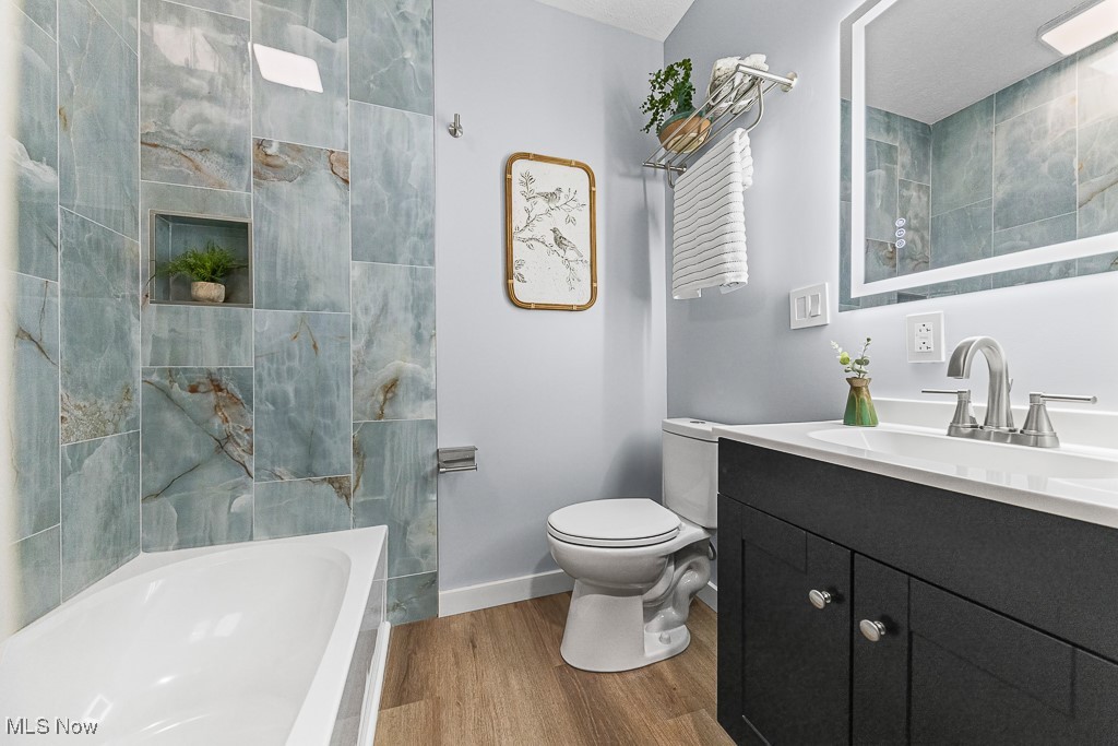3549 Kent Road Stow, OH 44224 - Photo 27 of 44 Bathroom with wood finished floors, vanity, and washtub / shower combination