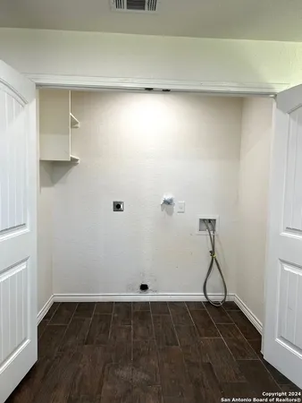 a view of a room with wooden floor and utility room
