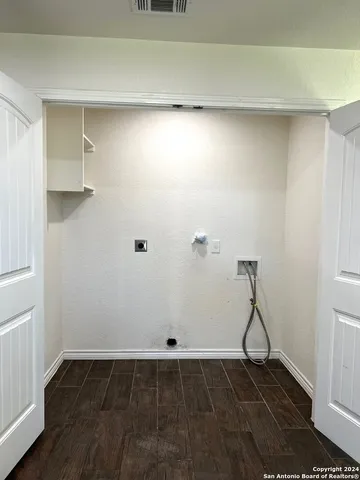 a view of a room with wooden floor and utility room