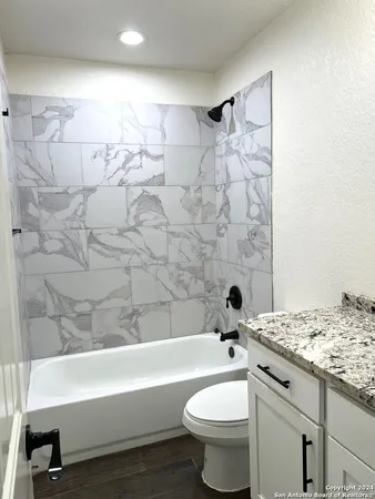 a bathroom with a sink a toilet and bathtub