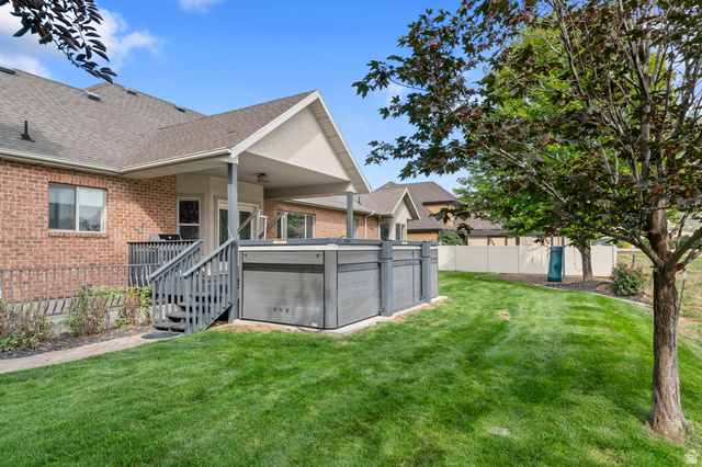 1501 West Elk Circle Mapleton, UT 84664 - Photo 4 of 39 Expansive backyard featuring a manicured lawn, covered patio, attached deck, and built-in spa