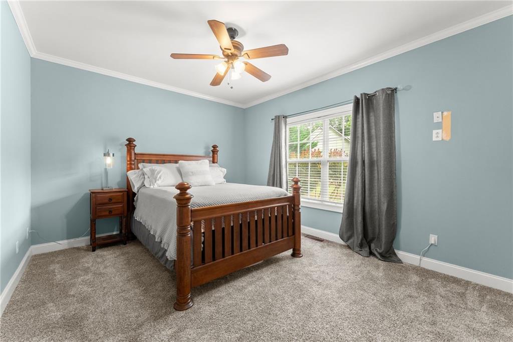 6643 Windvane Point Clermont, GA 30527 - Photo 37 of 88 a bed sitting in a room next to a window