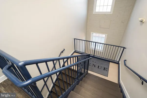 a view of staircase with black white walls
