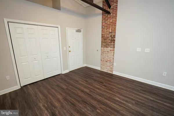 a view of a kitchen with wooden floor and electronic appliances