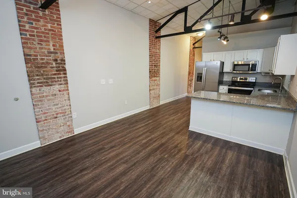 a kitchen with a refrigerator and a stove