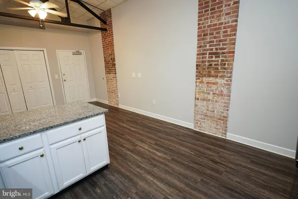a kitchen with granite countertop a refrigerator stove and microwave