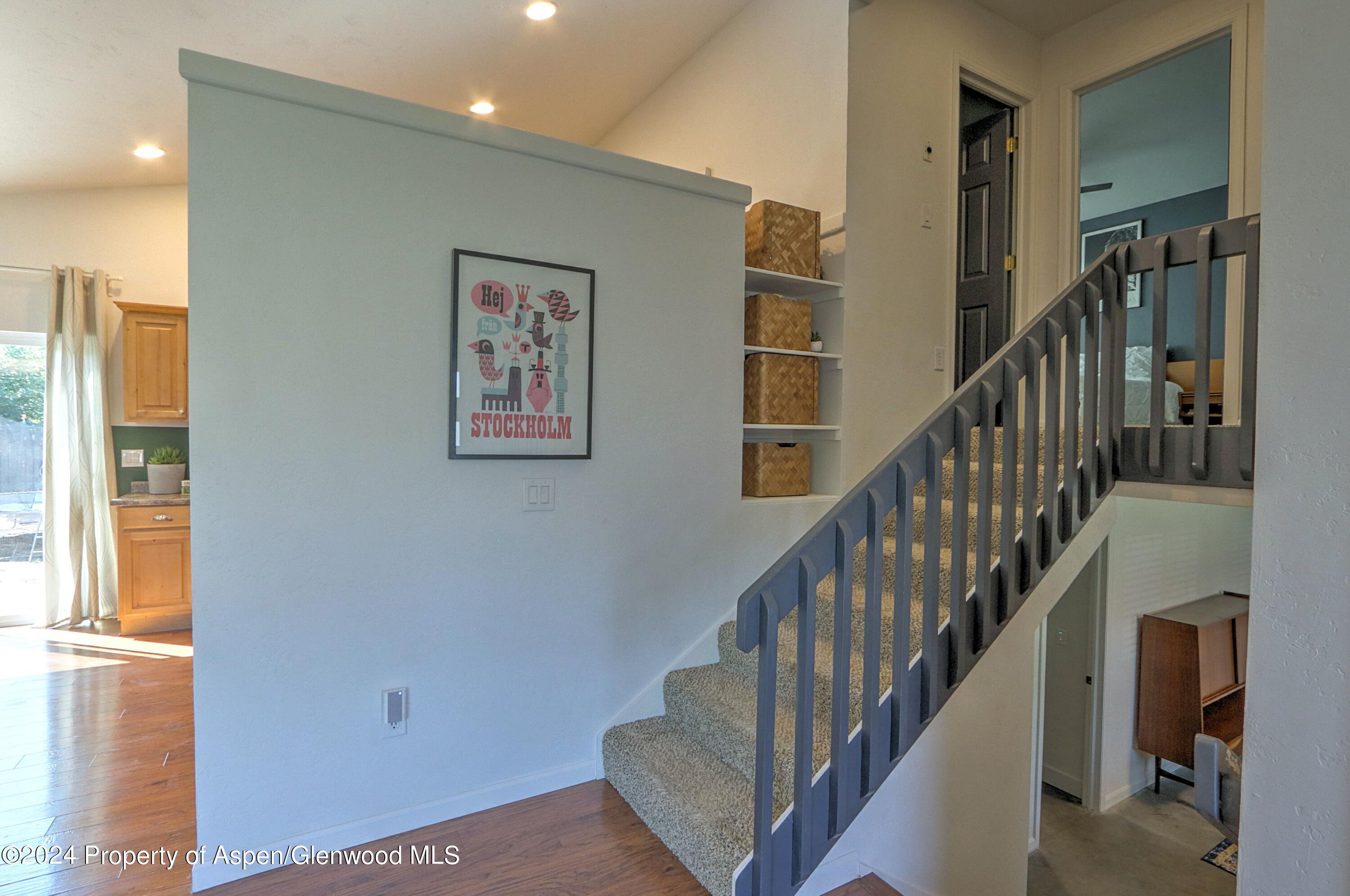 1329 East 8th Street Rifle, CO 81650 - Photo 13 of 26 a view of staircase with lots of frames and chairs