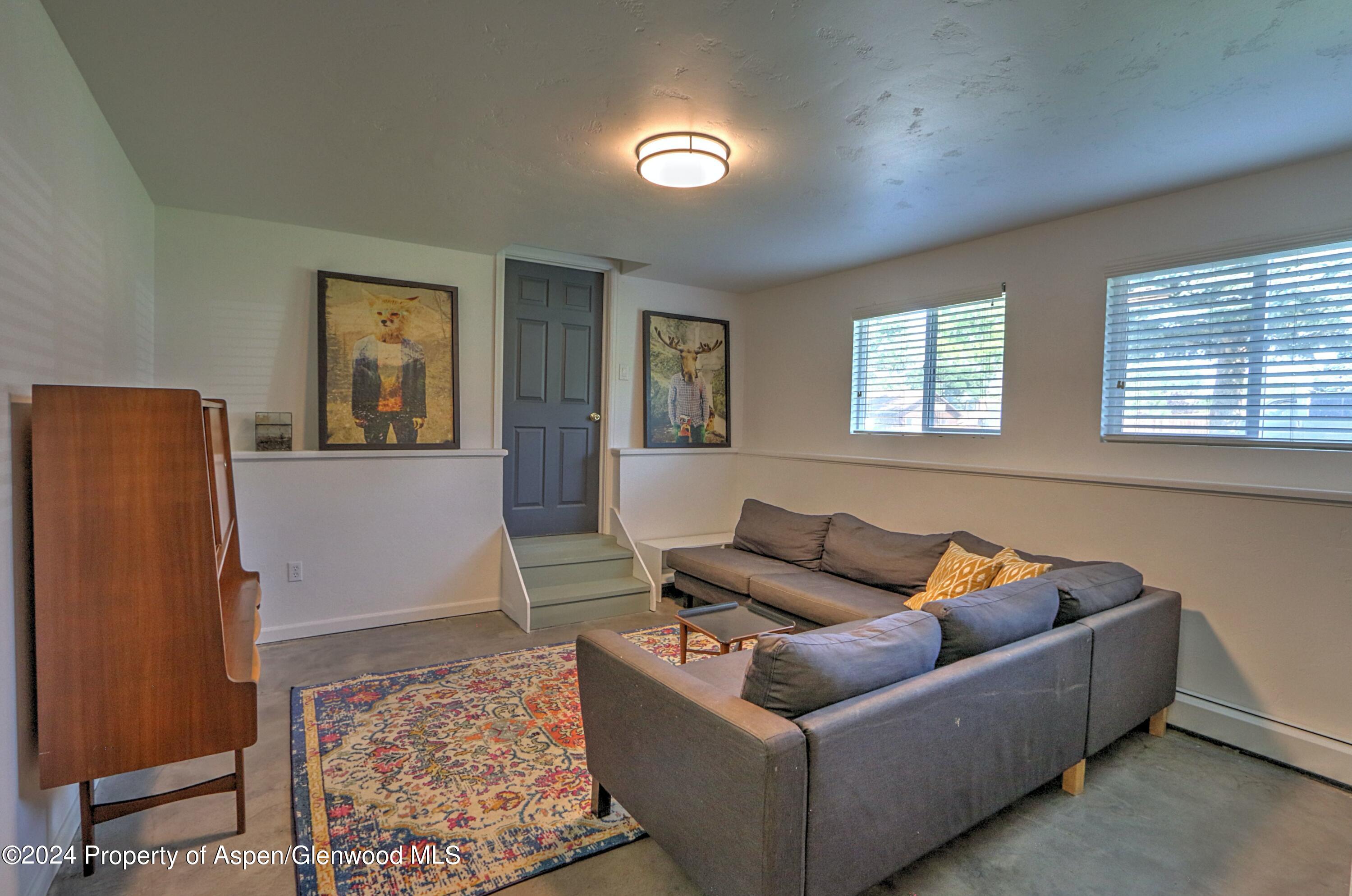1329 East 8th Street Rifle, CO 81650 - Photo 17 of 26 a living room with furniture and window