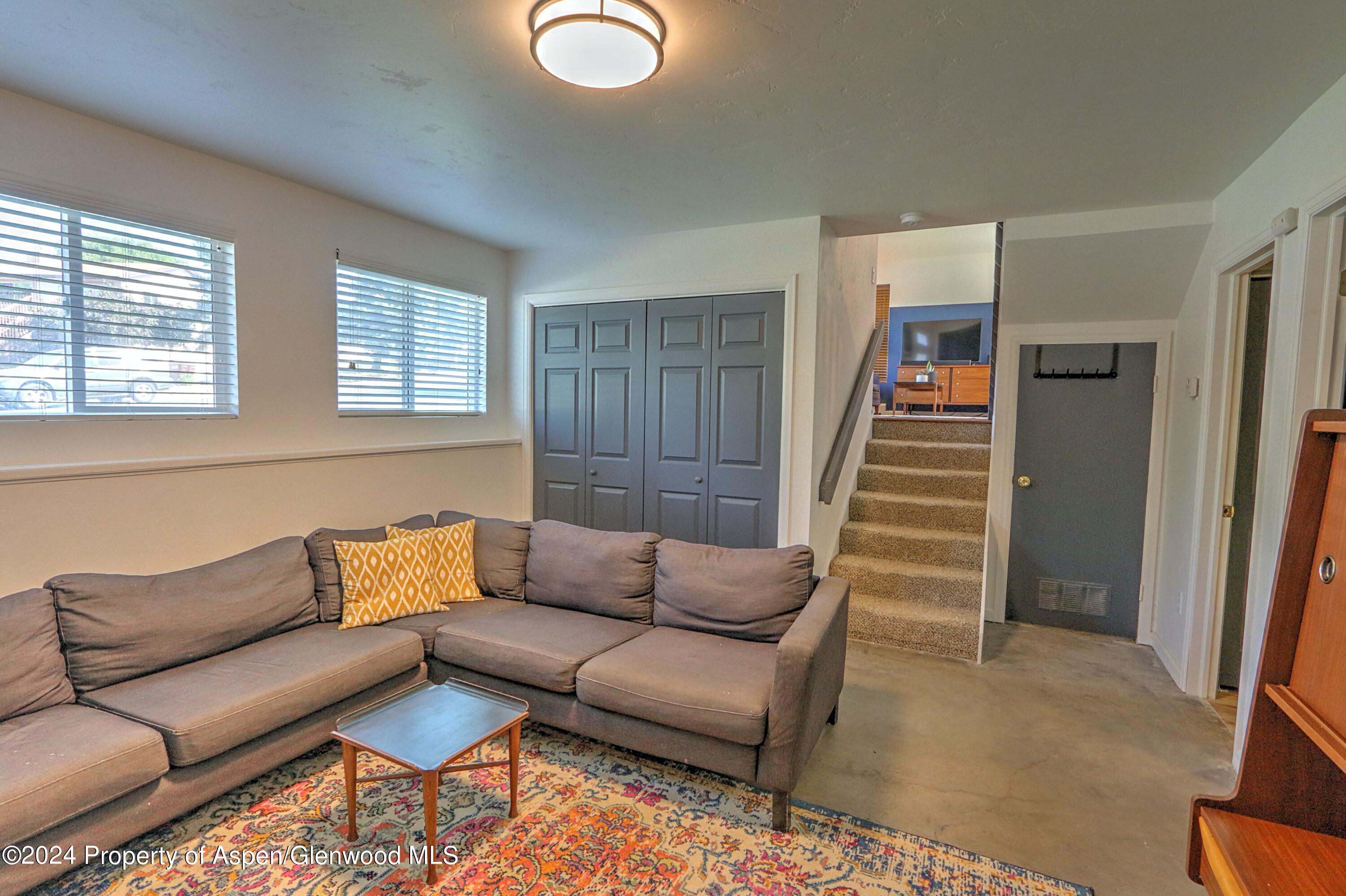 1329 East 8th Street Rifle, CO 81650 - Photo 18 of 26 a living room with furniture and a window