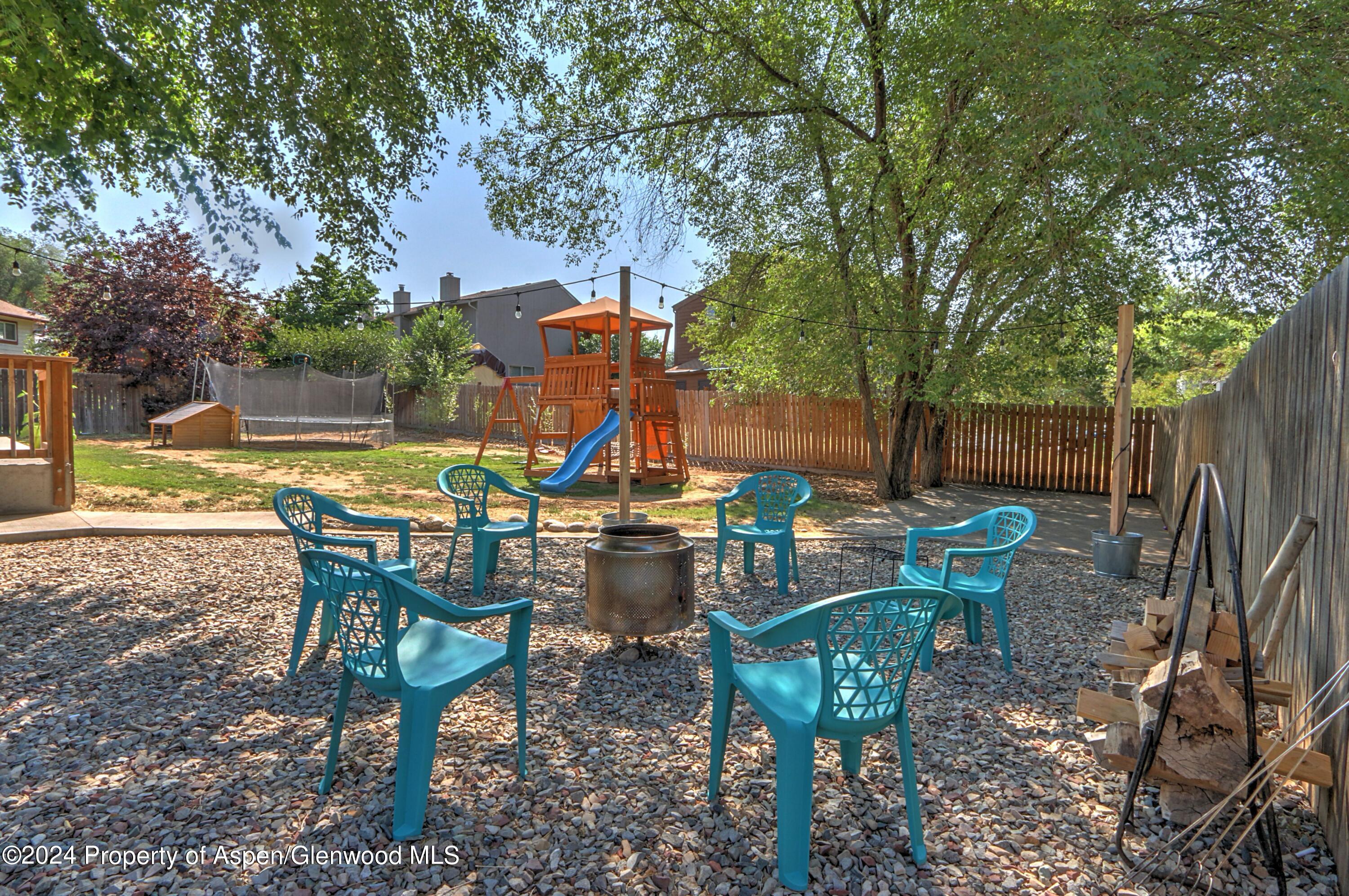 1329 East 8th Street Rifle, CO 81650 - Photo 24 of 26 a view of a sitting area with furniture and wooden fence