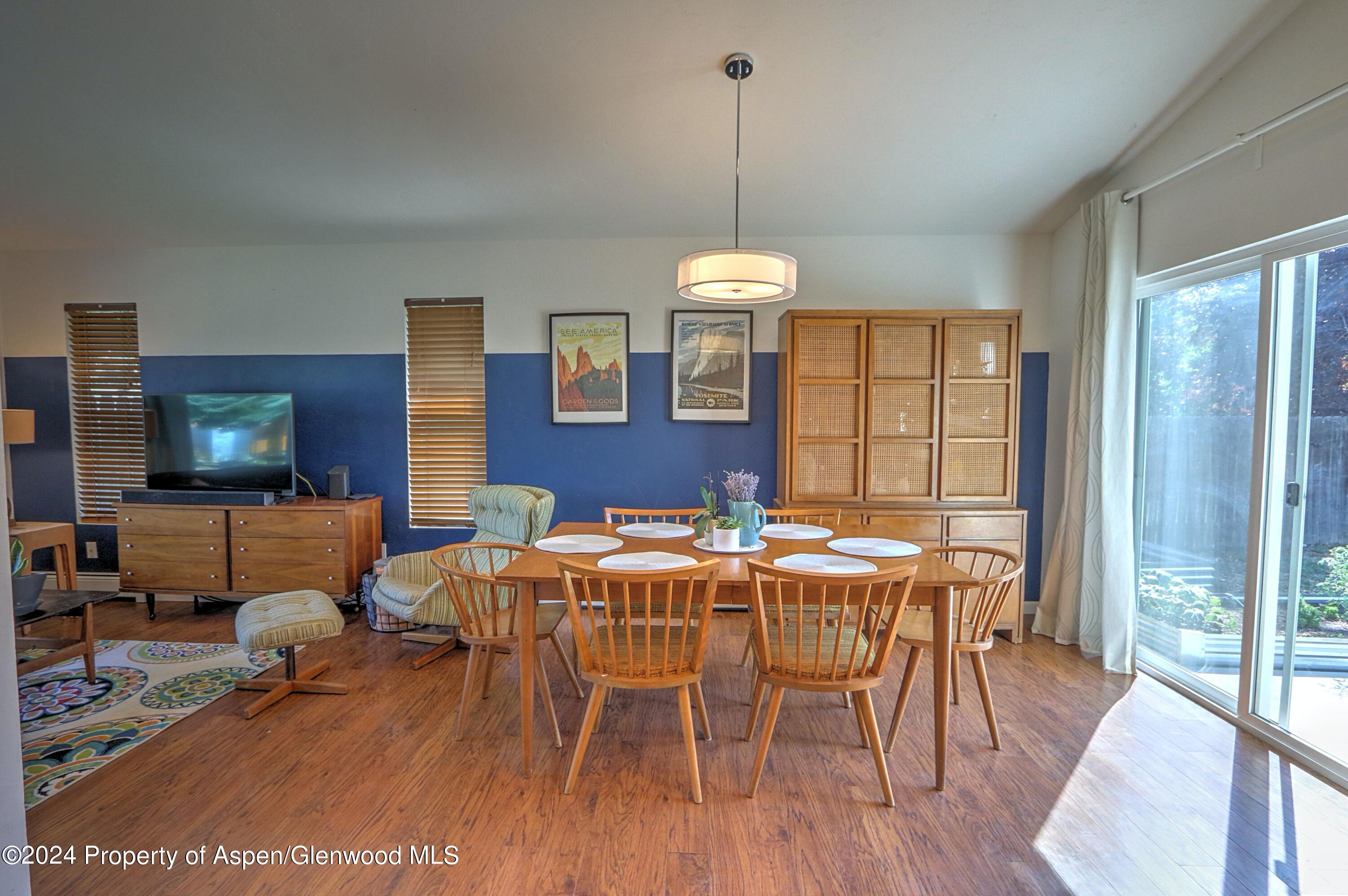1329 East 8th Street Rifle, CO 81650 - Photo 9 of 26 a view of a dining room with furniture window and wooden floor