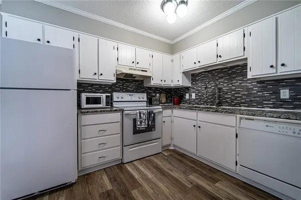 a kitchen with cabinets stainless steel appliances and sink