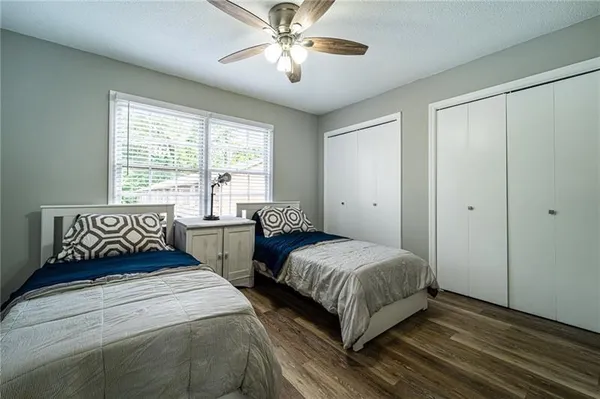 a bedroom with two beds and a chandelier