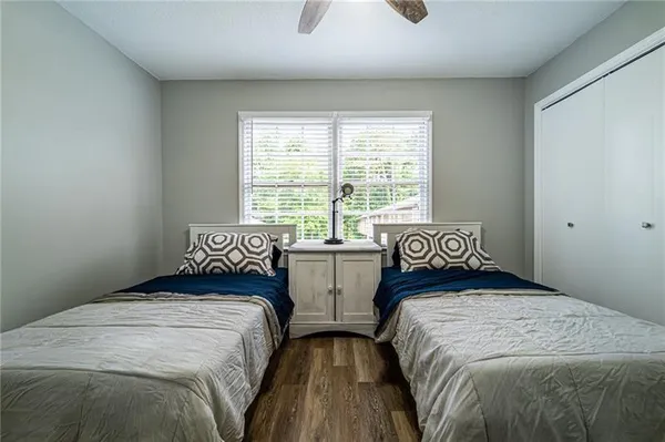 a bedroom with two beds and window