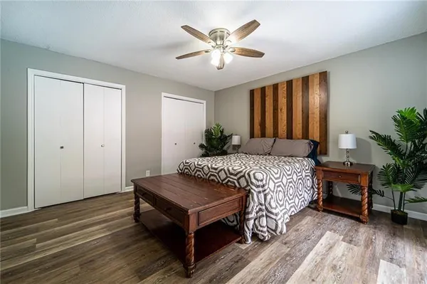 a bedroom with a bed table and chair