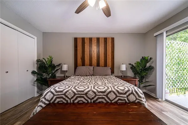 a bedroom with a bed potted plant with the outer view