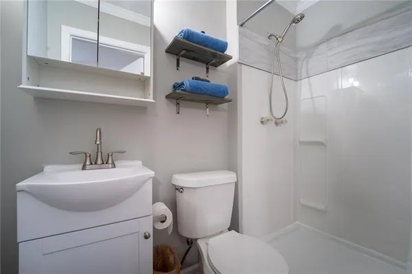 a bathroom with a toilet sink and shower
