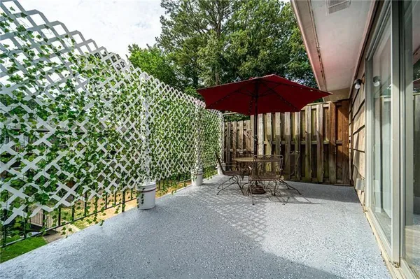 a view of a bench with wooden fence