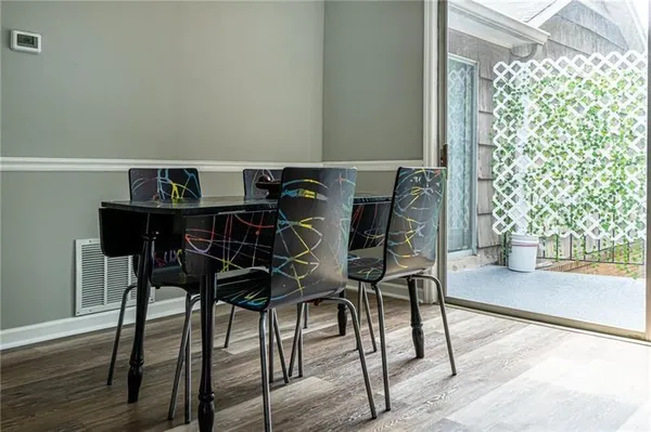 a view of a dining room with furniture and wooden floor