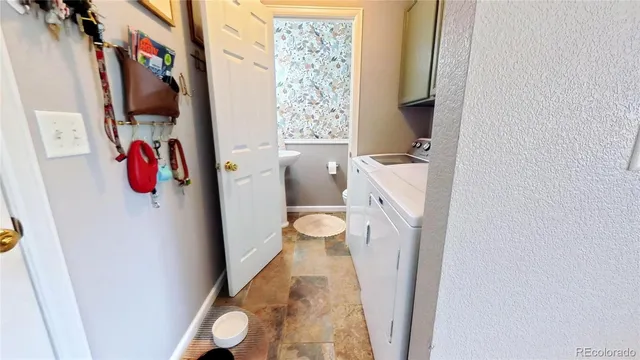 a bed sitting in a spacious bedroom next to a window